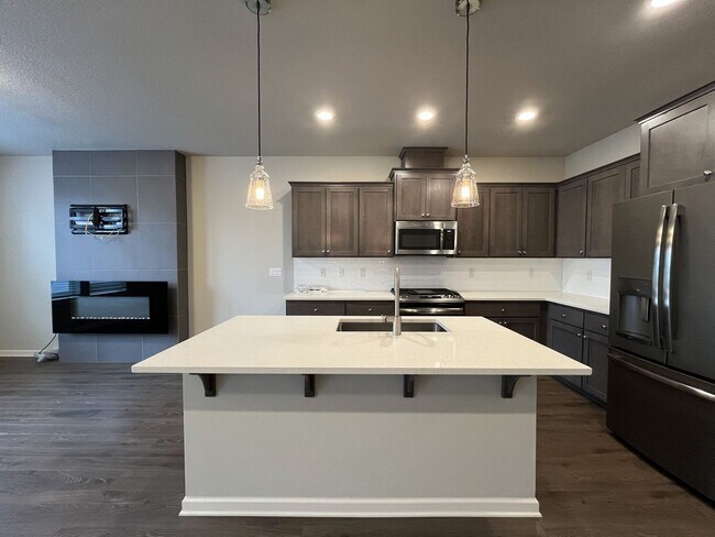 Photo - Stylish Two-Story Living with Fireplace, Island Kitchen & Private Primary Suite