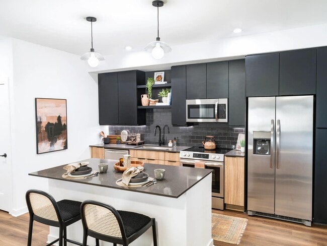 Our thoughtfully designed kitchen features a generous island, stainless appliances, and refined finishes that elevate everyday gatherings.