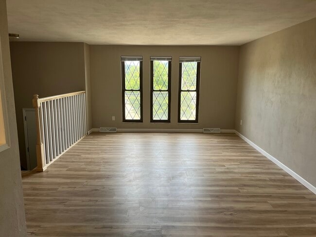 Living Room with new flooring and fresh paint. - 608 Sangree Rd