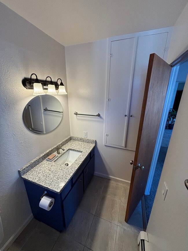 New granite counter top and hardware int he bathroom. - 1718 White Ave