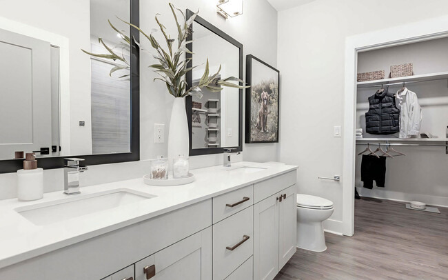 Luxurious bathroom with double vanity and spacious walk-in closet - Novel Cary Apartments