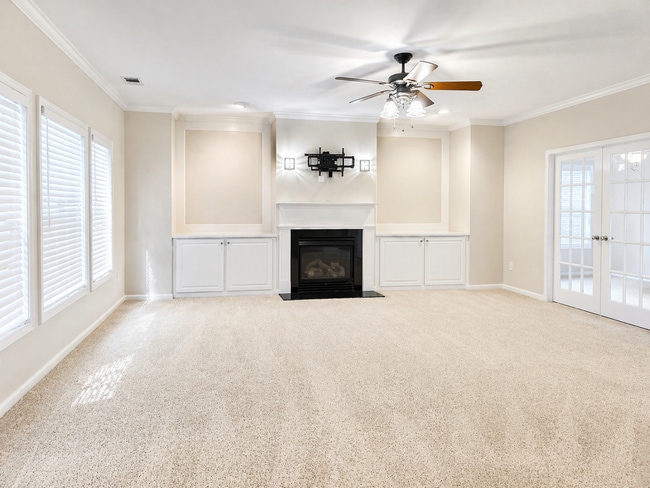 Open family room with preinstalled TV mount for easy setup and entertainment. - 2143 Somerset Pl SE