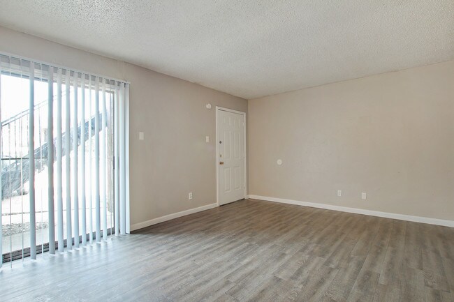 Living Room with Patio/Balcony - Norvell Court Apartments