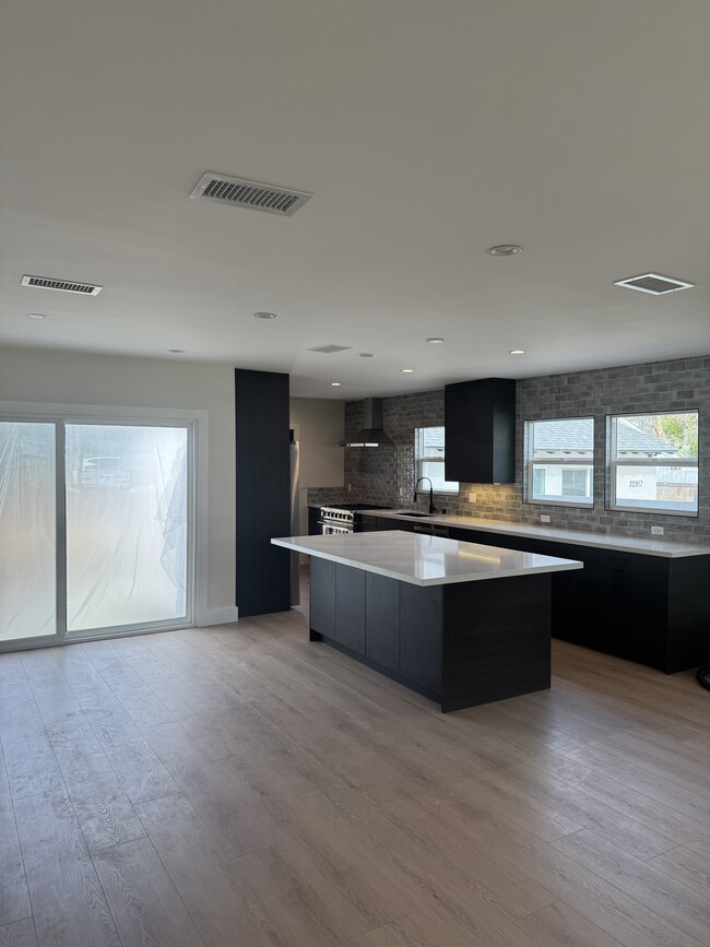 Kitchen island and living room space - 22919 Leonora Dr House