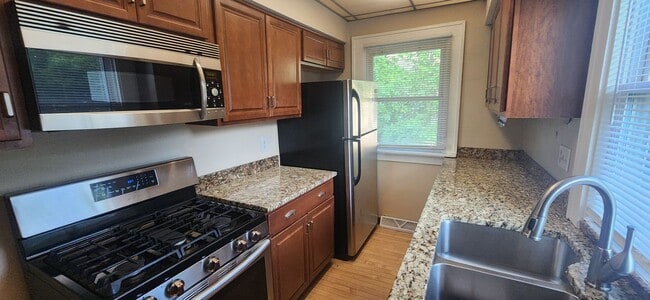 Building Photo - Fully fenced yard with stainless steel appliances including gas stove!
