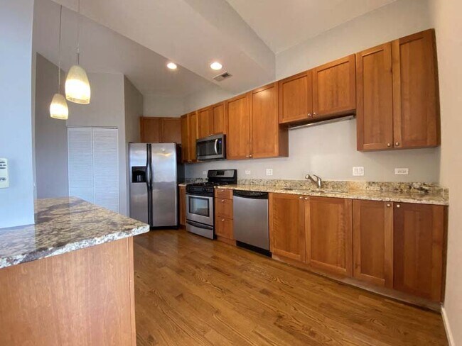 Spacious kitchen with hardwood floors and plenty of counterspace