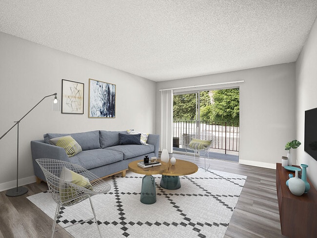 Hardwood floored living room with view of private patio.