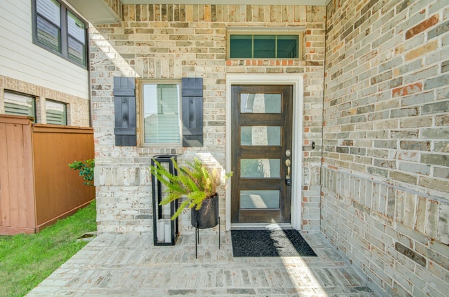 Aesthetically designed brick work completes the front door entrance.