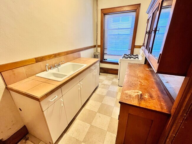 Experience the warmth of this inviting kitchen, perfect for culinary creations.