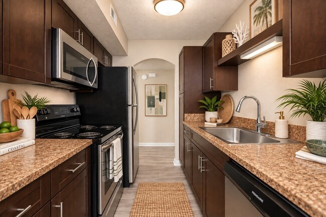 Elevate your culinary skills in this stylish kitchen at Indian Hills, featuring sleek appliances, modern finishes, and ample counter space. Ideal for both cooking and entertaining, this space is designed for your lifestyle. Schedule a visit today!