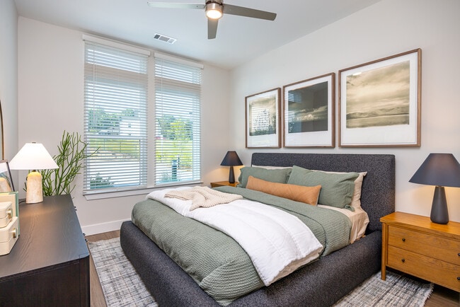 Primary bedroom with ceiling fan and hard surface vinyl plank flooring