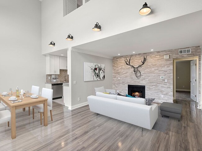 Living room with decorative stone wall and view of loft overhead. - Hughes Regency Apartments