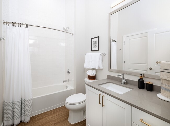 Design Collection I bath with grey countertop, white cabinetry, and hard surface flooring