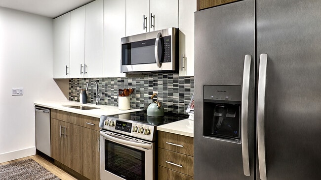 Apartment Kitchen with Stainless Steel Appliances and Quartz Countertops - Griffis West Palm