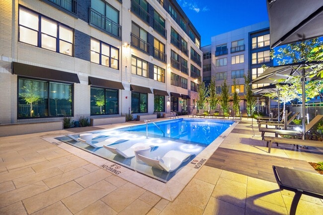 Resort-style pool with Sunbrellas and in-pool chaises