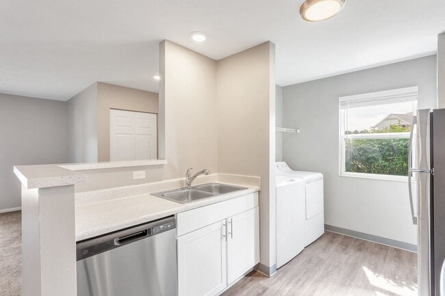 Enjoy modern kitchens featuring a large sink, dishwasher, stainless steel appliances, and bright natural lighting, professionally managed by Highlands Vista Group.