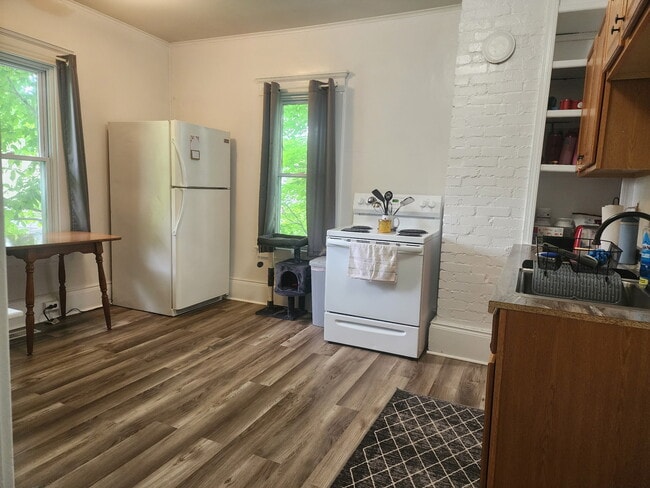 Eat in Kitchen includes table, stove, and refrigerator. - 89 S Main St Unit ApartmentA