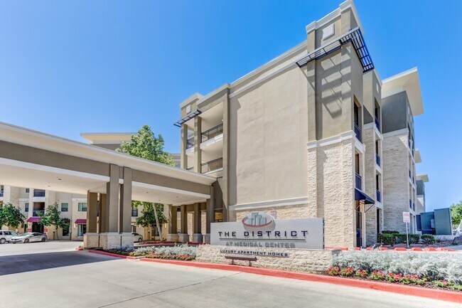 Entrance to Property & Leasing Office Parking - District at Medical Center Apartments