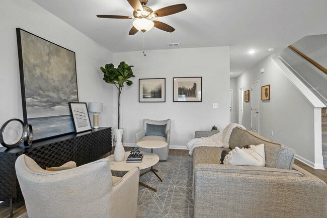 Spacious living room with ceiling fan - Covey Homes Kirkland