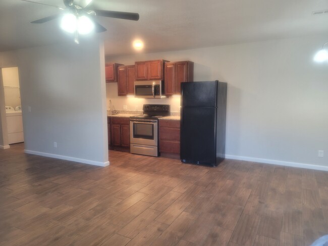 Living room into kitchen & dining - 2001 Sycamore Pl Townhome