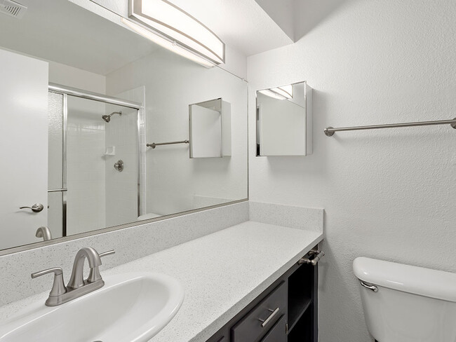 Modern styled bathroom with shower and tub. - Riverbridge Apartments