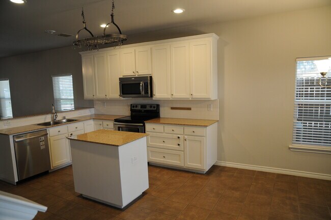 Kitchen w stainless appliances and granite