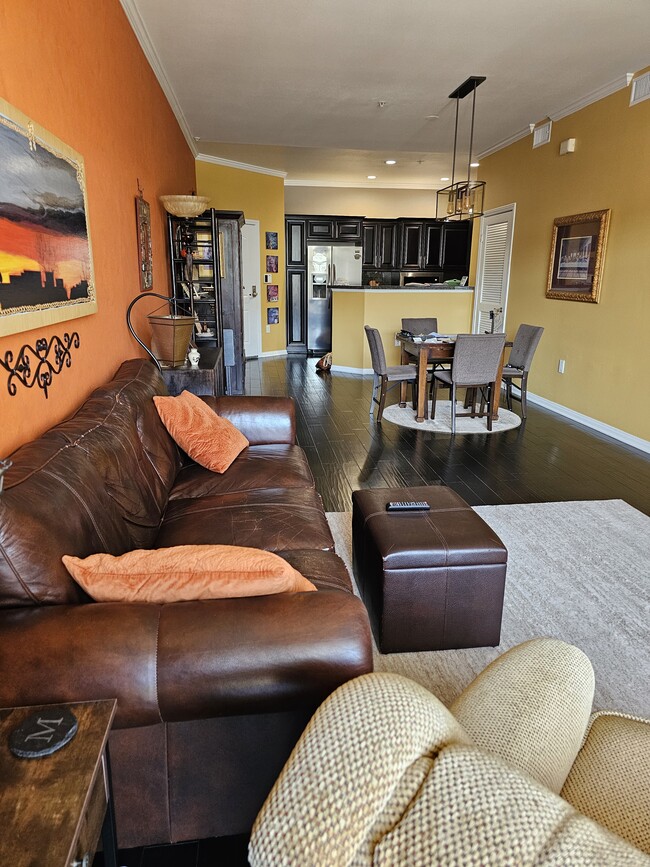 Living room with piano, fireplace and balcony
