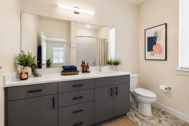 Modern bathroom with a spacious vanity, contemporary finishes, and ample storage at 27 West Apartments.