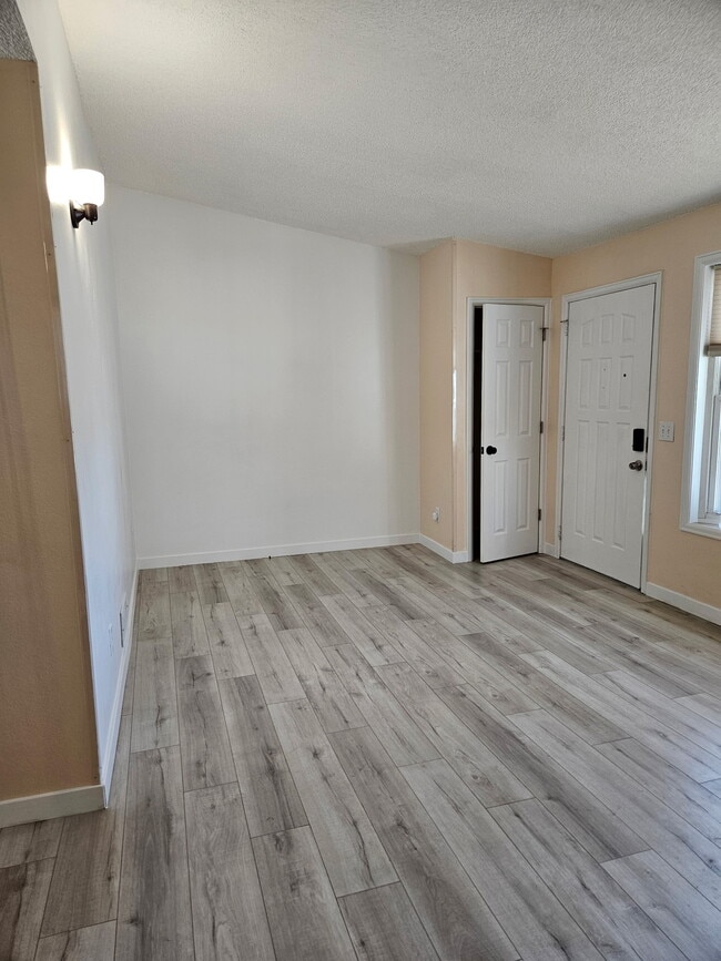 living room, closet and front door - 8184 Washington St