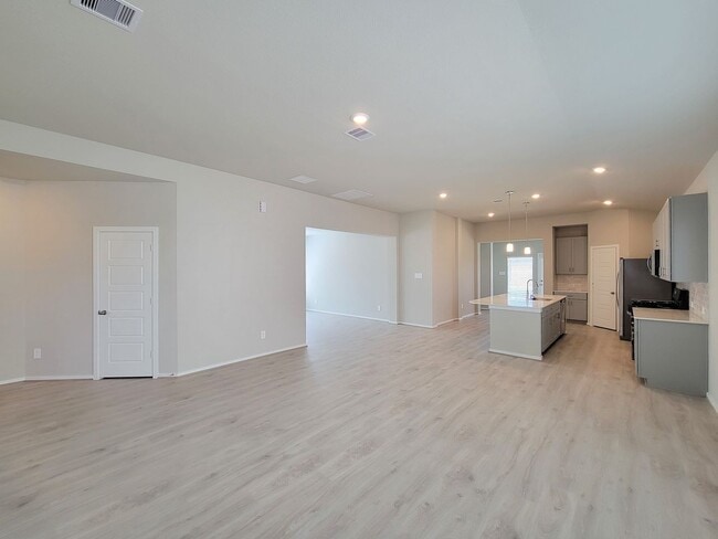 Photo - Single-story layout features a bright, open concept living area, dining space, and kitchen. Pebbl...