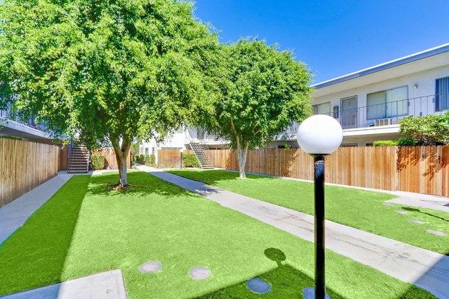 Lush Landscaping courtyard with 2 large trees - Cedar Court Apartments