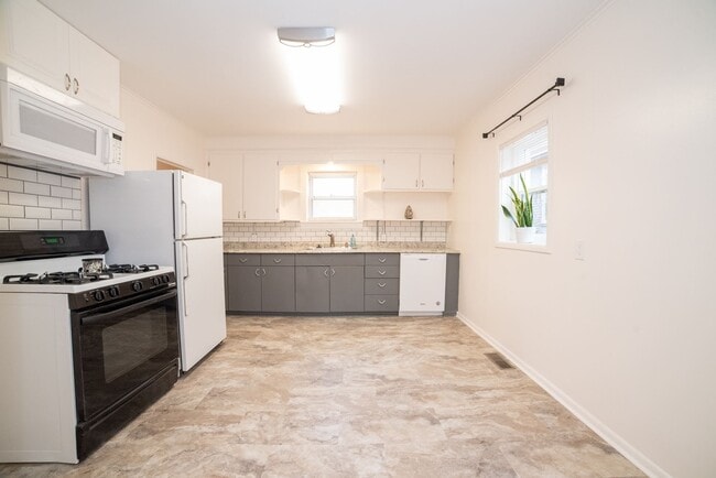 Kitchen, includes large sink, new dishwasher, over-range microwave, gas oven, fridge - 815 7th Ave N