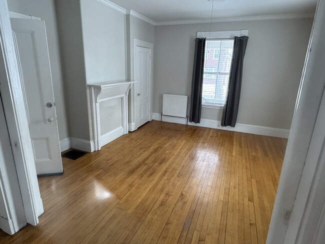 Front parlor. Could be used as living room or second bedroom. Room separated by two pocket doors. - 34 Elm St Unidad First Floor Apartment