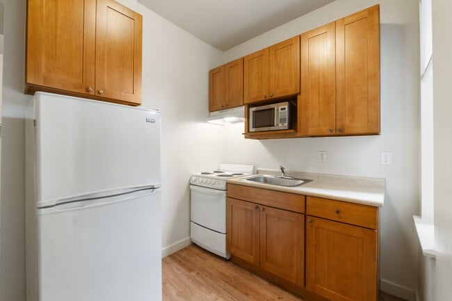 Studio kitchen with refrigerator, microwave, oven & range