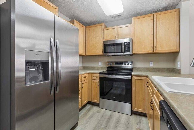 Thoughtfully designed with stainless steel appliances and warm cabinetry, this kitchen makes every meal feel inviting.