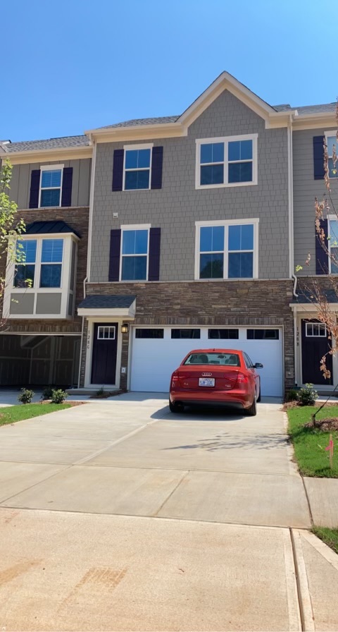 4-car driveway and 2-car garage - 128 Lanyard Dr Townhome