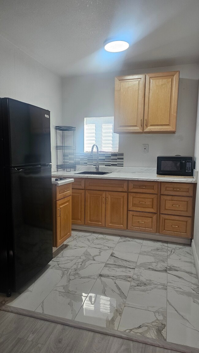 kitchen with microwave, refrigerator and electric stove - 2229 Goldhill Way Unit Back  Casita