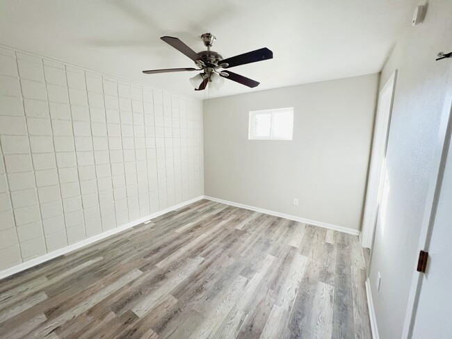 Sleep soundly in this spacious bedroom with a ceiling fan. - 2125 Banita St Apartments Unit 3