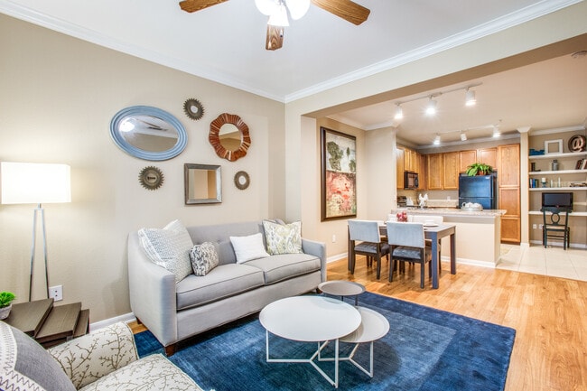 Fully decorated living room with laminate flooring - The Lodge at Spring Shadows Apartments