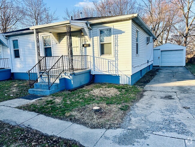 Front of the house with porch, driveway, and garage - 715 Koogler St Rental