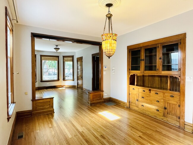 Dining Room with Tiffany chandelier & built-in cabinet - 4259 N Lawndale Ave Apartments Unit 1