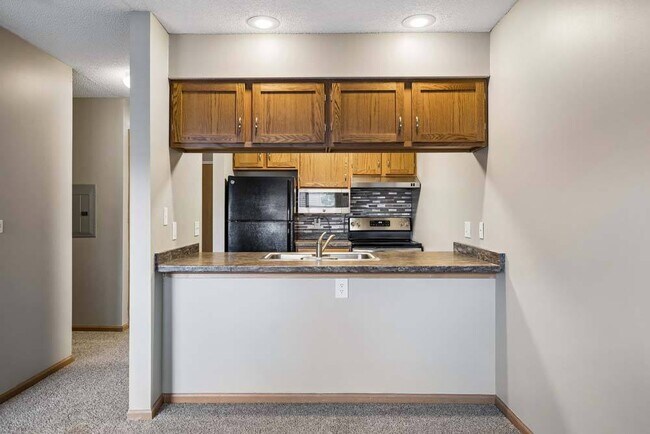 The breakfast bar creates a natural gathering place, while the thoughtfully designed kitchen offers everything you need for easy everyday living.
