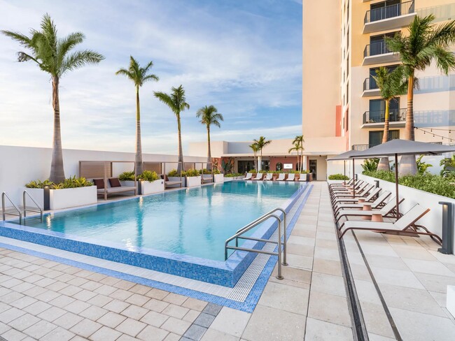 Relax in style with our resort-style pool, cabanas, and lounge seating. - Modera St. Petersburg Apartments