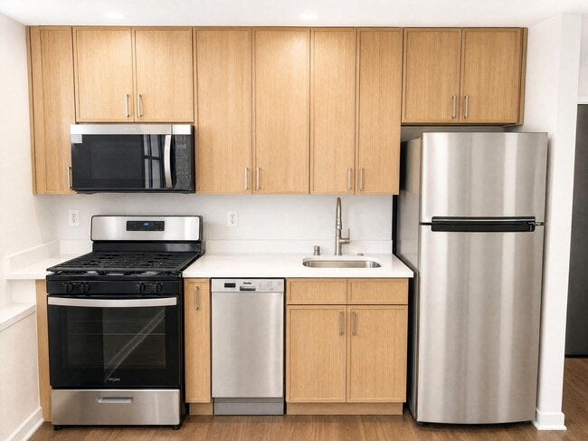 Newly redesigned kitchen featuring modern cabinetry, stainless steel appliances, and sleek countertops.