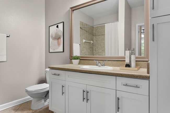 Step into elegance in this contemporary bathroom, featuring a spacious vanity and chic accents.