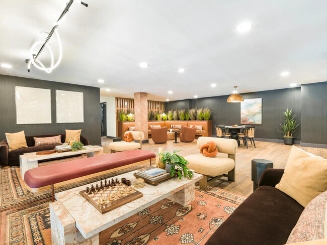 Lounge, connect, or unwind—our social spaces are designed to feel like an extension of home, with cozy nooks and conversation-ready seating. - Modera Higley Commons