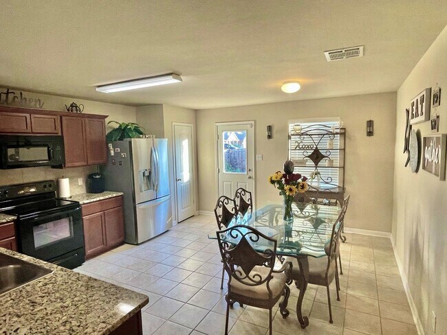 Photo - Elegant four-bedroom corner-lot home with hardwood floors, modern kitchen, master suite, and comm...