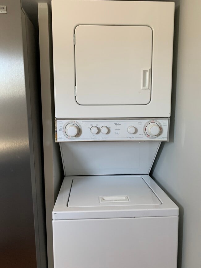 Stack-able Washer & Dryer and a Dishwasher next to sink. Storage shelf on top of area. - 97 Washington street Casa Adosada