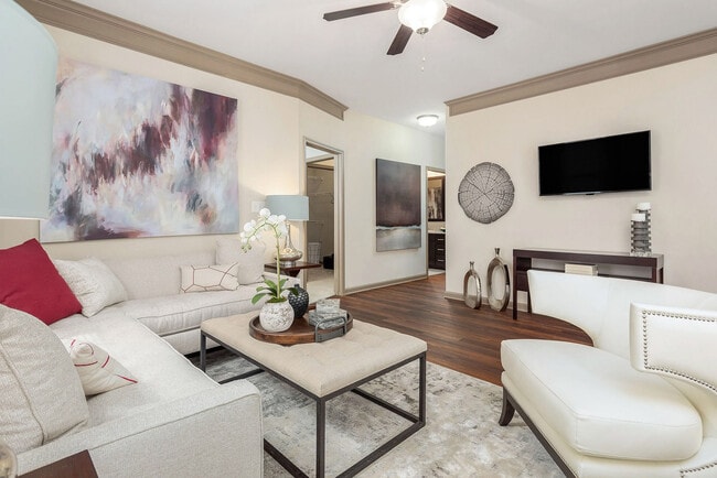 Spacious open-concept living room with modern finishes, crown molding, and stylish design—elevated apartment living in Charlotte.