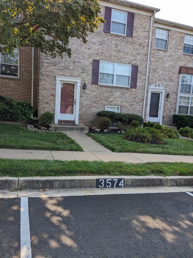 Front view w/assigned parking in front of the house